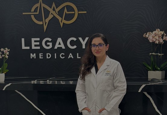 The Legacy Medical reception wall with the practice's gold logo
